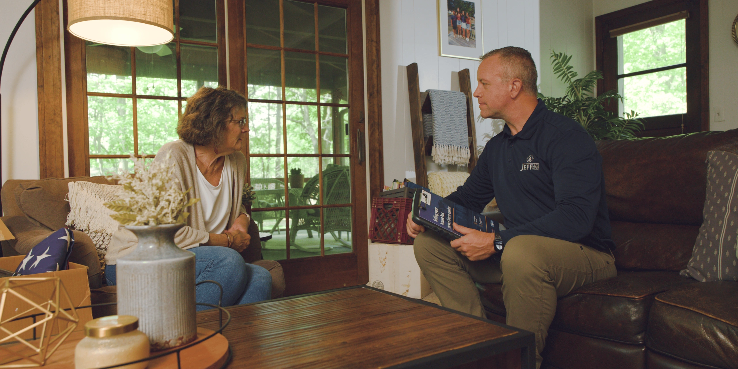 Jeff Buys Your House team member meeting with a homeowner to understand their situation and provide guidance on selling their house.