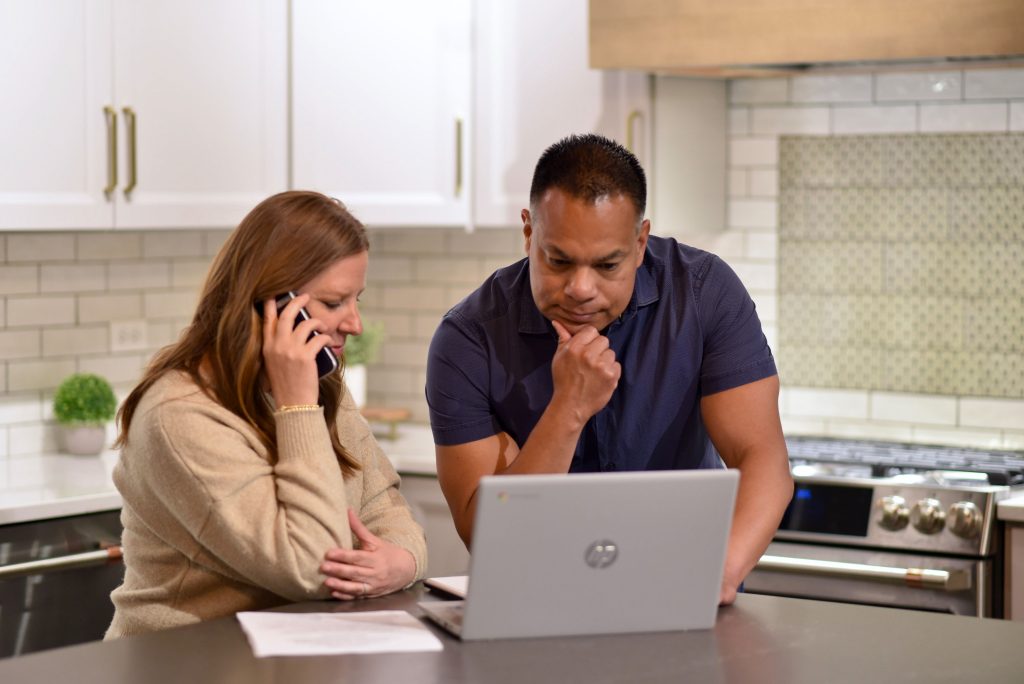 Homeowners speaking with a Jeff Buys Your House home buying specialist about selling their fixer-upper as-is.