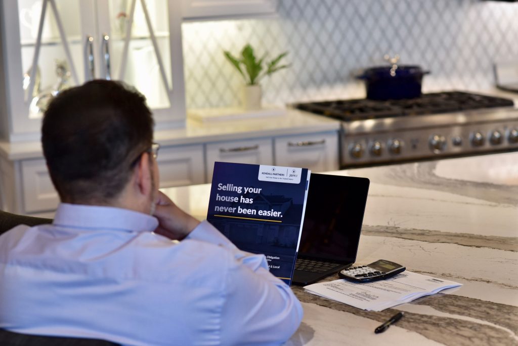 Homeowner reviewing information about selling a house as-is with Jeff Buys Your House.